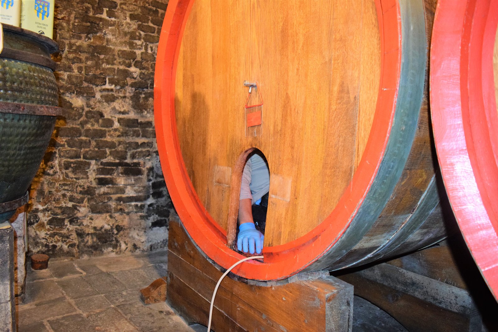 man in wine barrel in Montepulciano, ouritalianjourney.com