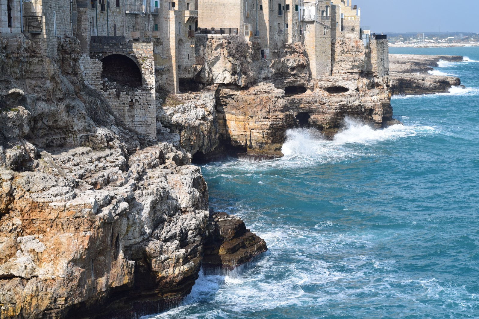 Polignano a Mare is a beautiful town with turquoise waters and amazing cliffs and caves. Located in Puglia, Italy, ouritalianjourney.com