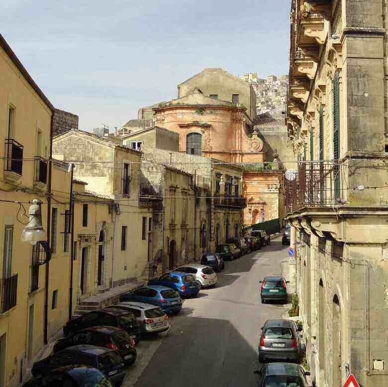 street in Modica, Sicily: Discover the beauty and our funny true story. ouritalianjourney.com  