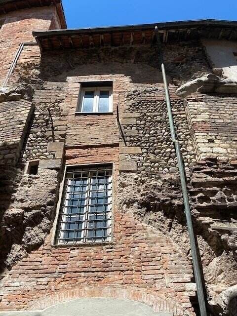 An ancient part of the outside wall of the Anfiteatro in Lucca Centro - ouritalianjourney.com