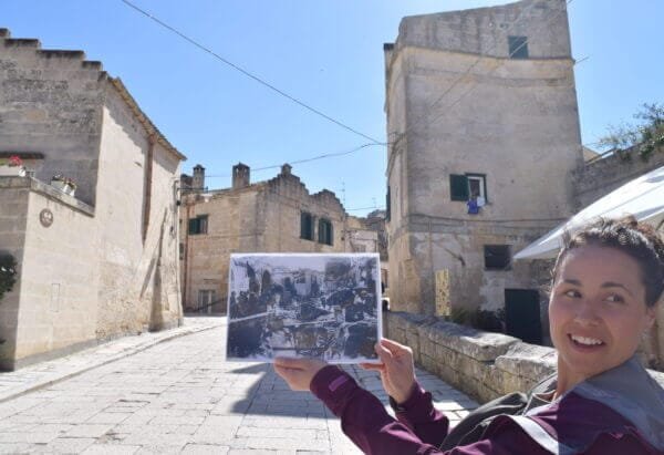Matera with our guide Sara showing an old photo of the Sassi ouritalianjourney.com